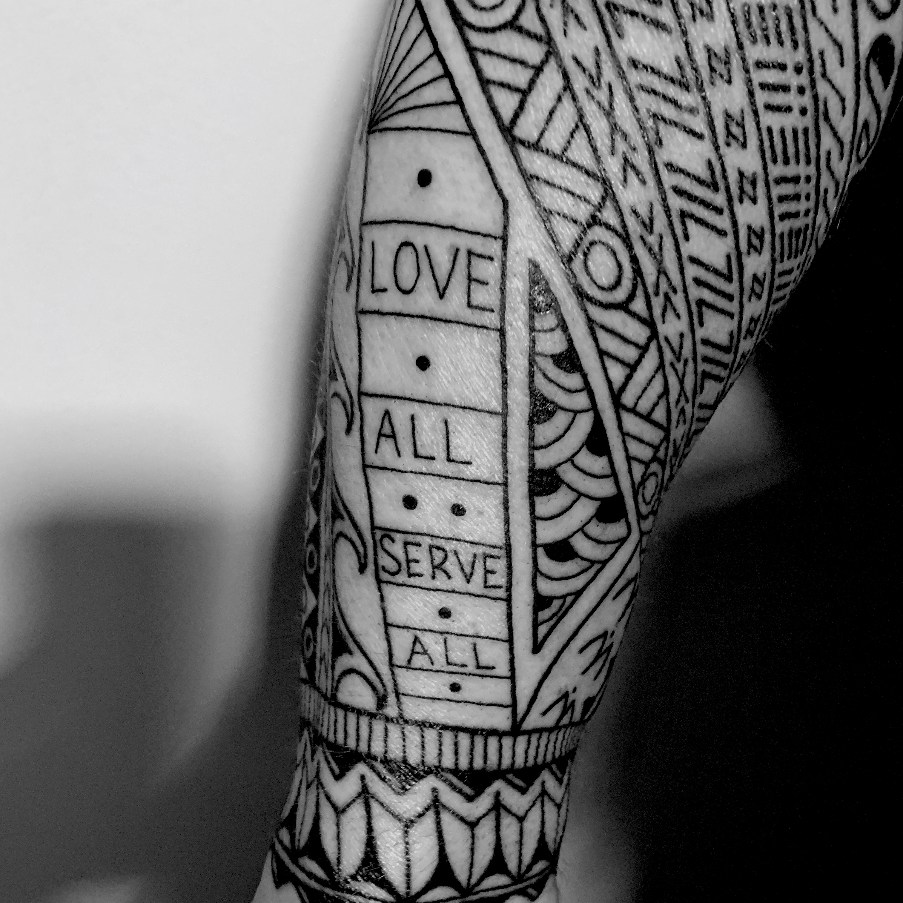 This section represents the neck of a guitar and contains the words LOVE ALL SERVE ALL, a nod to Hard Rock Cafe.